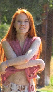 Very cute redhead stripping of her blouse, revealing her perfect round breasts
